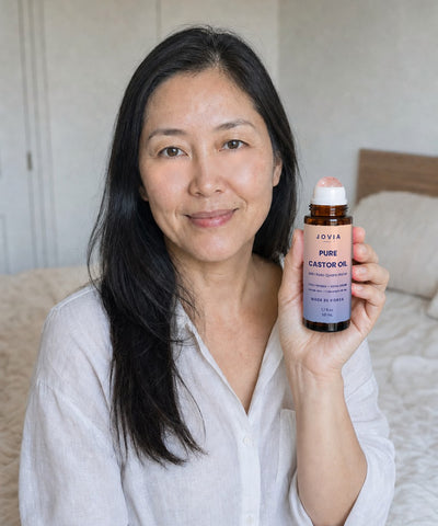 Woman holding Jovia Pure Castor Oil