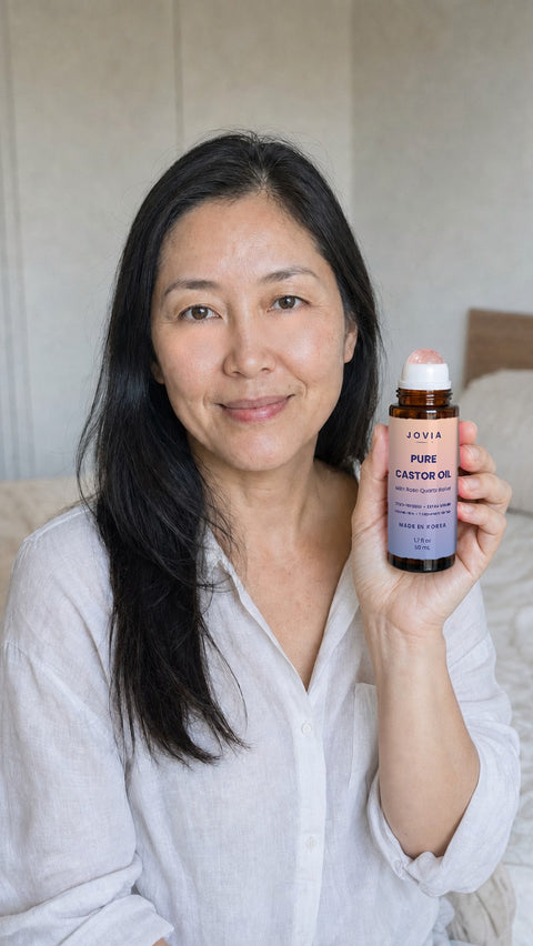 Woman holding Jovia Pure Castor Oil