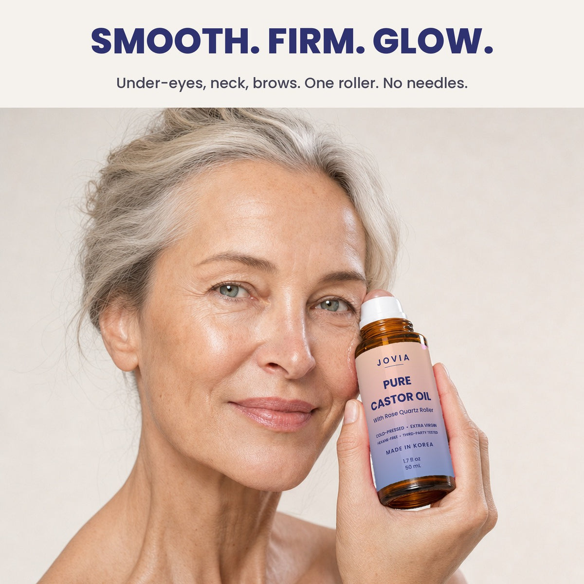 Woman rolling Jovia castor oil on her cheekbone