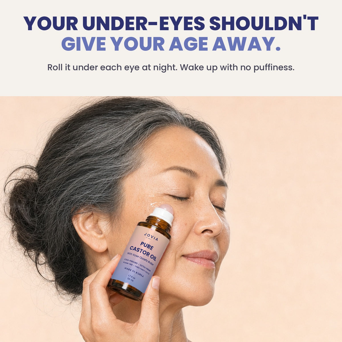 Woman rolling Jovia castor oil under her eye