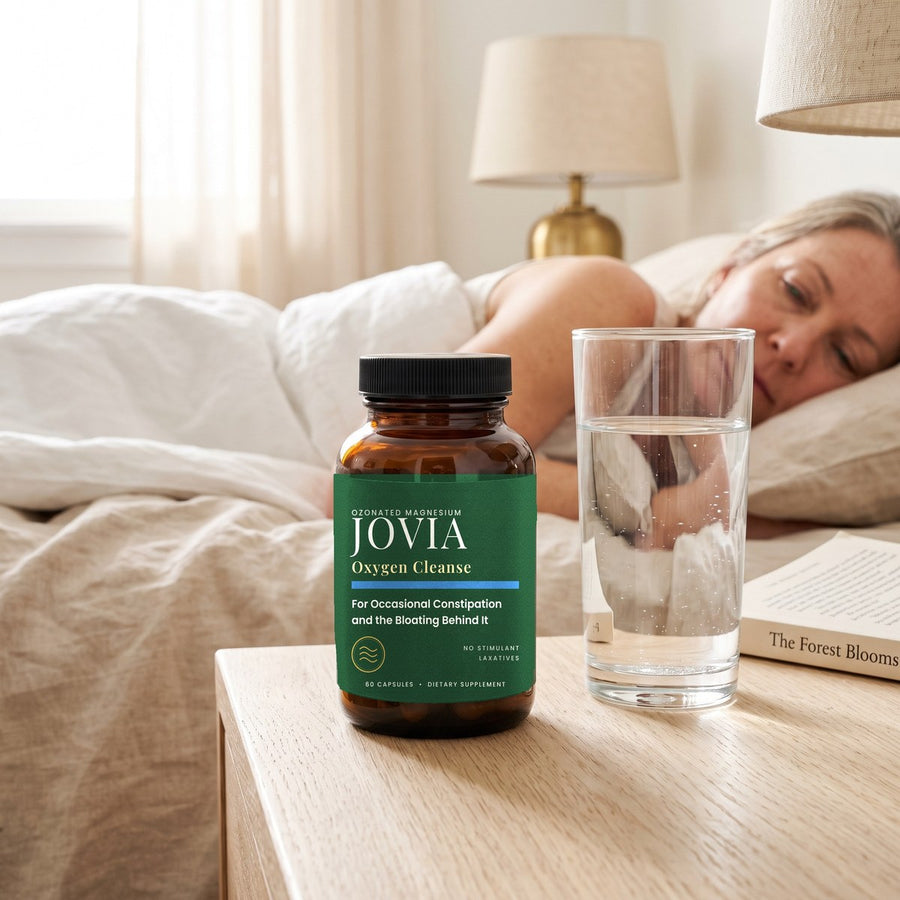 Jovia jar on a nightstand beside a full glass of water